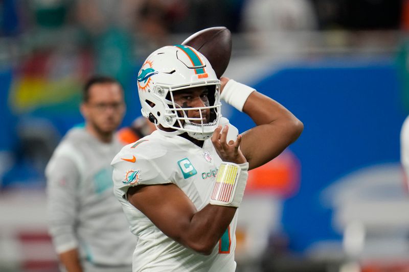 Miami Dolphins quarterback Tua Tagovailoa throws during pregame of an NFL football game against the Detroit Lions, Sunday, Oct. 30, 2022, in Detroit. (AP Photo/Paul Sancya)