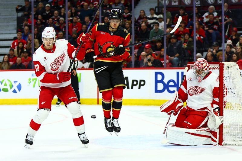 Feb 26, 2026; Ottawa, Ontario, CAN; Detroit Red Wings defenseman Simon Edvinsson (77) and Ottawa Senators center Tim Stutzle (18) react to a shot taken on goaltender John Gibson (36) during the first period at Canadian Tire Centre. Mandatory Credit: Keito Newman-Imagn Images