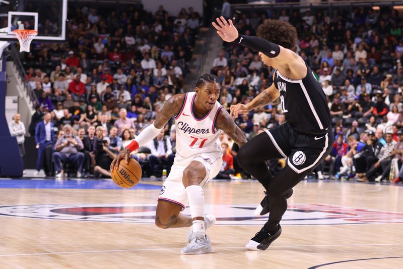 OCEANSIDE, CALIFORNIA - OCTOBER 08: Kevin Porter Jr. #77 of the Los Angeles Clippers tries to move past Jalen Wilson #22 of the Brooklyn Nets in the first quarter of the preseason game at Frontwave Arena on October 08, 2024 in Oceanside, California. NOTE TO USER: User expressly acknowledges and agrees that, by downloading and or using this photograph, User is consenting to the terms and conditions of the Getty Images License Agreement. (Photo by Joe Scarnici/Getty Images)