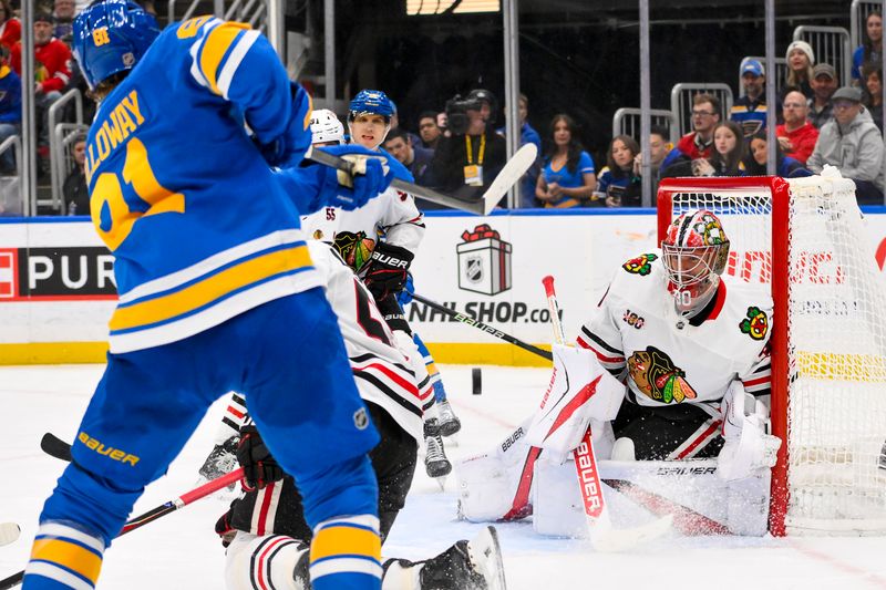 Dec 12, 2025; St. Louis, Missouri, USA; Chicago Blackhawks goaltender Spencer Knight (30) defends the net against St. Louis Blues left wing Dylan Holloway (81) during the second period at Enterprise Center. Mandatory Credit: Jeff Curry-Imagn Images