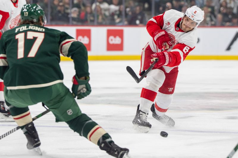 Feb 25, 2025; Saint Paul, Minnesota, USA; Detroit Red Wings defenseman Ben Chiarot (8) shoots against Minnesota Wild left wing Marcus Foligno (17) in the first period at Xcel Energy Center. Mandatory Credit: Matt Blewett-Imagn Images