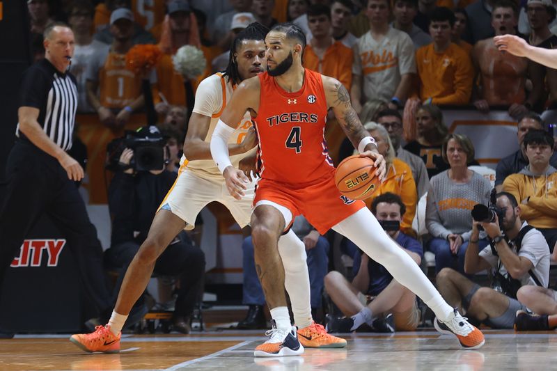 Feb 28, 2024; Knoxville, Tennessee, USA; Auburn Tigers forward Johni Broome (4) moves the ball against Tennessee Volunteers forward Jonas Aidoo (0) during the second half at Thompson-Boling Arena at Food City Center. Mandatory Credit: Randy Sartin-USA TODAY Sports