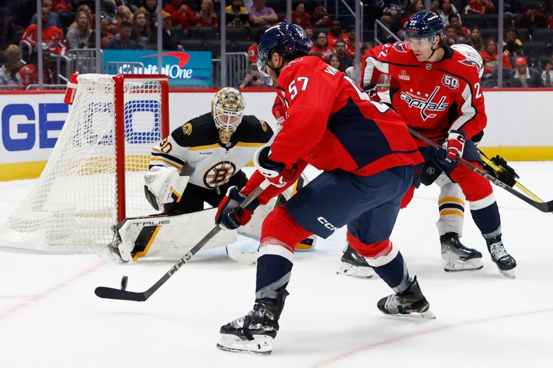 Oct 5, 2024; Washington, District of Columbia, USA; Washington Capitals defenseman Trevor van Riemsdyk (57) scores a goal on Boston Bruins goaltender Brandon Bussi (30) in the third period at Capital One Arena. Mandatory Credit: Geoff Burke-Imagn Images