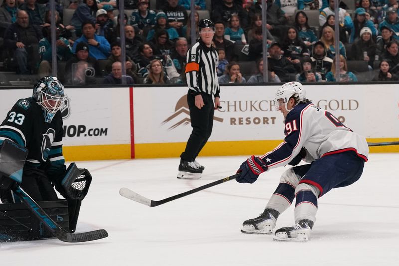 Jan 6, 2026; San Jose, California, USA;  San Jose Sharks goaltender Alex Nedeljkovic (33) makes a save against Columbus Blue Jackets center Kent Johnson (91) in the third period at SAP Center at San Jose. Mandatory Credit: David Gonzales-Imagn Images