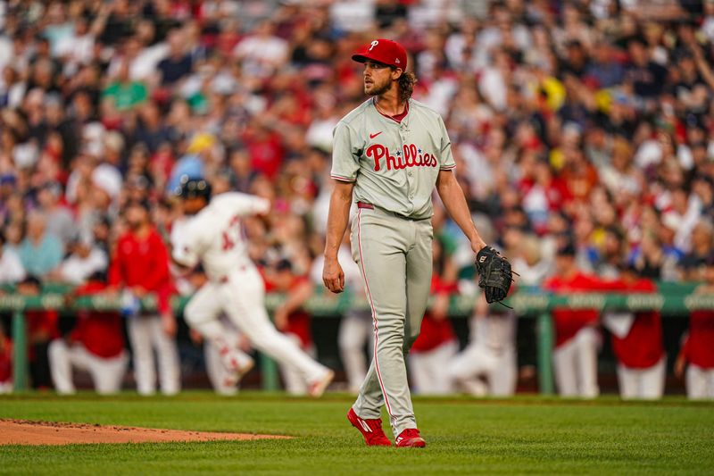 Jun 13, 2024; Boston, Massachusetts, USA; Philadelphia Phillies starting pitcher Aaron Nola (27) watches as Boston Red Sox second baseman Enmanuel Valdez (47) hits a double in the second inning at Fenway Park. Mandatory Credit: David Butler II-USA TODAY Sports