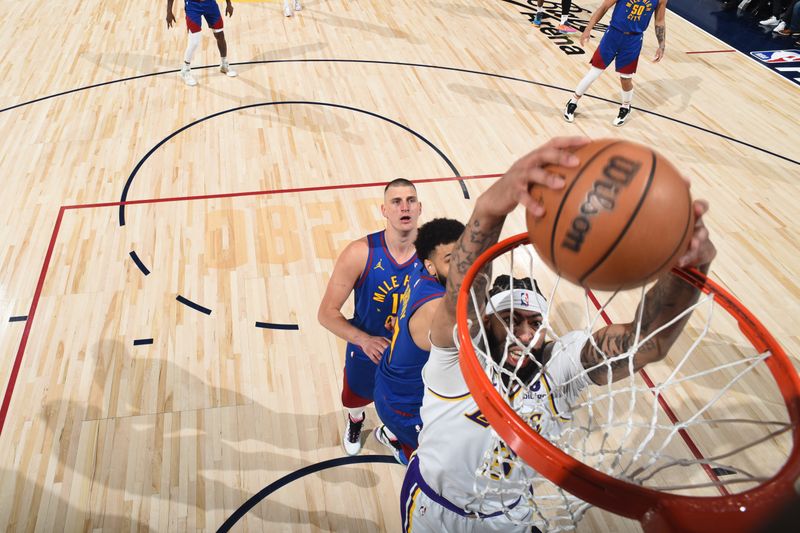 DENVER, CO - APRIL 20: Anthony Davis #3 of the Los Angeles Lakers dunks the ball during the game against the Denver Nuggets during Round 1 Game 1 of the 2024 NBA Playoffs on April 20, 2024 at the Ball Arena in Denver, Colorado. NOTE TO USER: User expressly acknowledges and agrees that, by downloading and/or using this Photograph, user is consenting to the terms and conditions of the Getty Images License Agreement. Mandatory Copyright Notice: Copyright 2024 NBAE (Photo by Garrett Ellwood/NBAE via Getty Images)