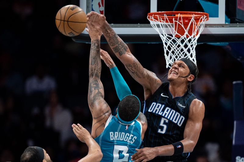 CHARLOTTE, NORTH CAROLINA - APRIL 05: Paolo Banchero #5 of the Orlando Magic blocks a shot from Miles Bridges #0 of the Charlotte Hornets in the third quarter during their game at Spectrum Center on April 05, 2024 in Charlotte, North Carolina. NOTE TO USER: User expressly acknowledges and agrees that, by downloading and or using this photograph, User is consenting to the terms and conditions of the Getty Images License Agreement. (Photo by Jacob Kupferman/Getty Images)