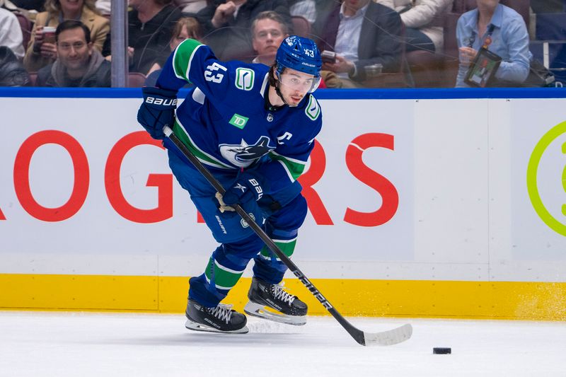 Mar 21, 2024; Vancouver, British Columbia, CAN; Vancouver Canucks defenseman Quinn Hughes (43) handles the puck against the Montreal Canadiens in the third period at Rogers Arena. Vancouver won 4 -1. Mandatory Credit: Bob Frid-USA TODAY Sports