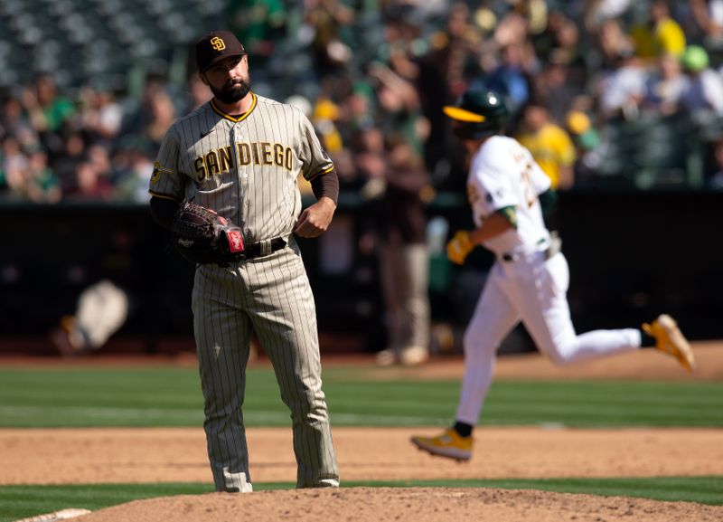 Sep 16, 2023; Oakland, California, USA; San Diego Padres starting pitcher Matt Waldron (61) reacts to allowing a solo home run to Oakland Athletics second baseman Zack Gelof (20) during the sixth inning at Oakland-Alameda County Coliseum. Mandatory Credit: D. Ross Cameron-USA TODAY Sports