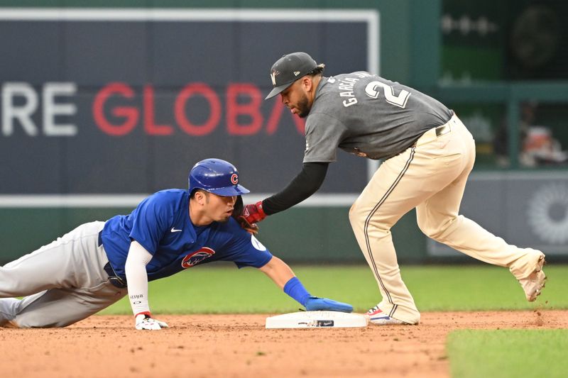 Aug 31, 2024; Washington, District of Columbia, USA; Chicago Cubs right fielder Seiya Suzuki (27) slides safely into second base in front of Washington Nationals second baseman Luis Garcia Jr. (2) during the eighth inning at Nationals Park. Mandatory Credit: Rafael Suanes-USA TODAY Sports