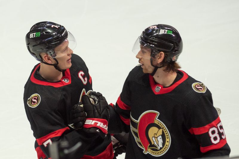 Oct 22, 2022; Ottawa, Ontario, CAN; Ottawa Senators left wing Brady Tkachuk (7) shares a moment with defenseman Jake Sanderson (85) following his goal in the third period against the Arizona Coyotes at the Canadian Tire Centre. Mandatory Credit: Marc DesRosiers-USA TODAY Sports