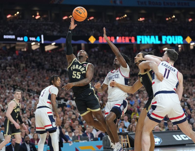 Apr 8, 2024; Glendale, AZ, USA;  Purdue Boilermakers guard Lance Jones (55) shoots against Connecticut Huskies guard Tristen Newton (2) in the national championship game of the Final Four of the 2024 NCAA Tournament at State Farm Stadium. Mandatory Credit: Robert Deutsch-USA TODAY Sports