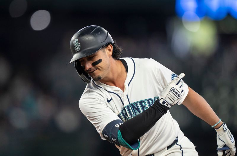 Jun 15, 2024; Seattle, Washington, USA; Seattle Mariners third baseman Josh Rojas (4) gestures toward the dugout after hitting a two-run single eighth inning against the Texas Rangers at T-Mobile Park. Mandatory Credit: Stephen Brashear-USA TODAY Sports