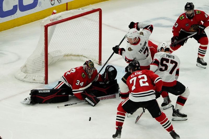 Feb 17, 2024; Chicago, Illinois, USA; Chicago Blackhawks goalie Petr Mrazek (34) makes a save on Ottawa Senators left wing Brady Tkachuk (7) during the second period at United Center. Mandatory Credit: David Banks-USA TODAY Sports