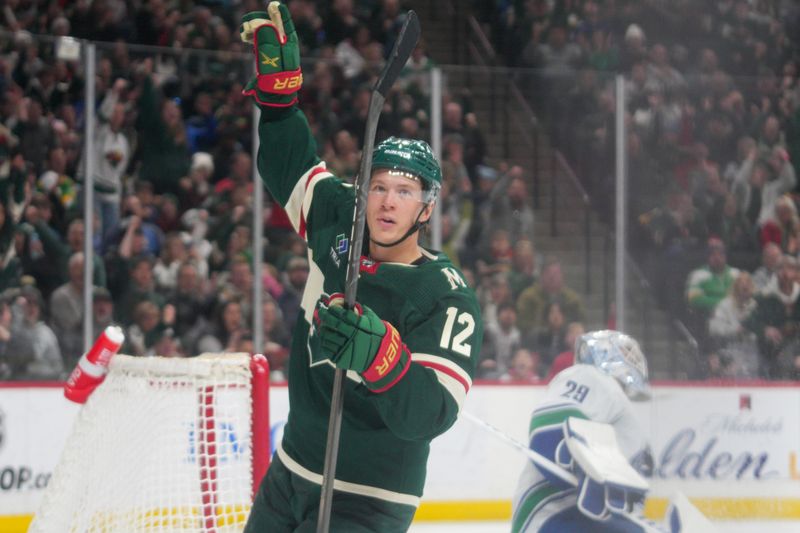 Feb 19, 2024; Saint Paul, Minnesota, USA; Minnesota Wild left winger Matt Boldy (12) celebrates a breakaway goal against Vancouver Canucks goaltender Casey DeSmith (29) in the second period at Xcel Energy Center. Mandatory Credit: Matt Blewett-USA TODAY Sports