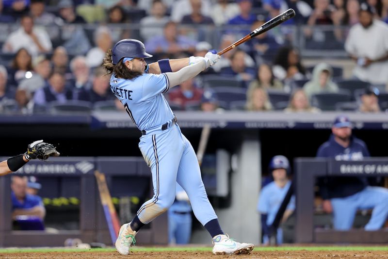 Sep 19, 2023; Bronx, New York, USA; Toronto Blue Jays shortstop Bo Bichette (11) follows through on a two run home run against the New York Yankees during the fifth inning at Yankee Stadium. Mandatory Credit: Brad Penner-USA TODAY Sports