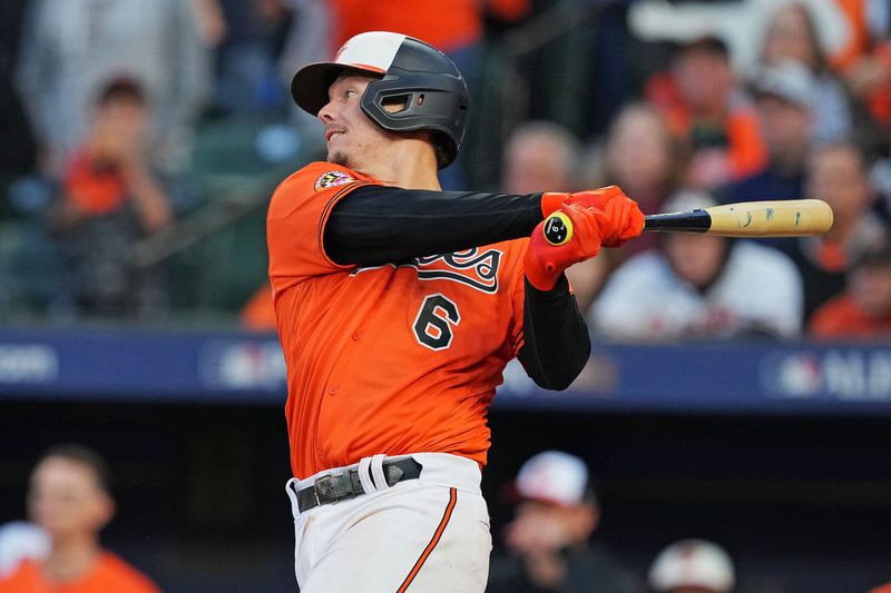 Oct 8, 2023; Baltimore, Maryland, USA; Baltimore Orioles first baseman Ryan Mountcastle (6) hits an RBI sacrifice fly during the fourth inning against the Texas Rangers during game two of the ALDS for the 2023 MLB playoffs at Oriole Park at Camden Yards. Mandatory Credit: Mitch Stringer-USA TODAY Sports