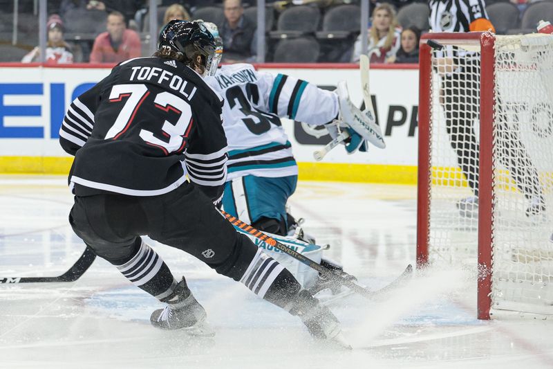 Dec 1, 2023; Newark, New Jersey, USA; New Jersey Devils right wing Tyler Toffoli (73) looks up as the puck deflects off the crossbar behind San Jose Sharks goaltender Kaapo Kahkonen (36) during the second period at Prudential Center. Mandatory Credit: Vincent Carchietta-USA TODAY Sports