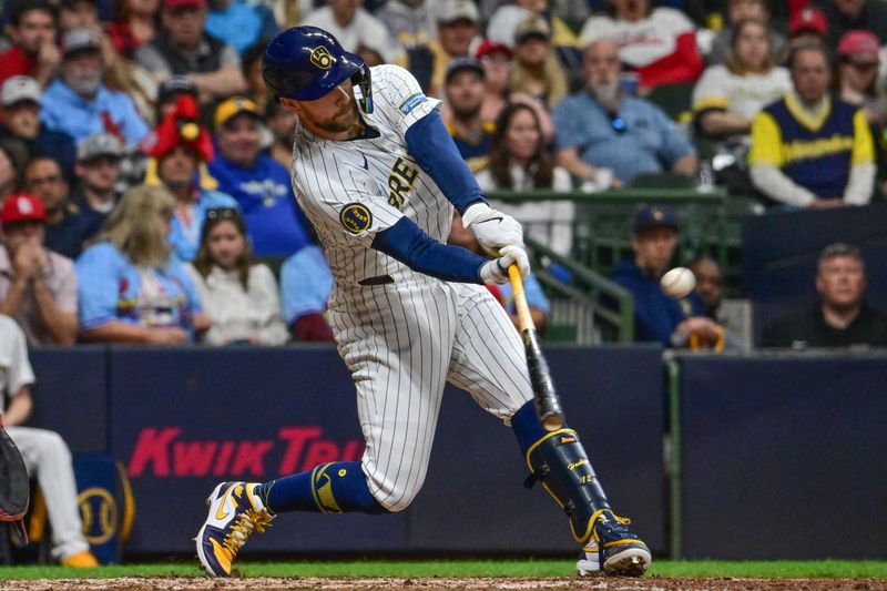 May 11, 2024; Milwaukee, Wisconsin, USA; Milwaukee Brewers first baseman Rhys Hoskins (12) hits a three-run home run against the St. Louis Cardinals in the seventh inning at American Family Field. Mandatory Credit: Benny Sieu-USA TODAY Sports