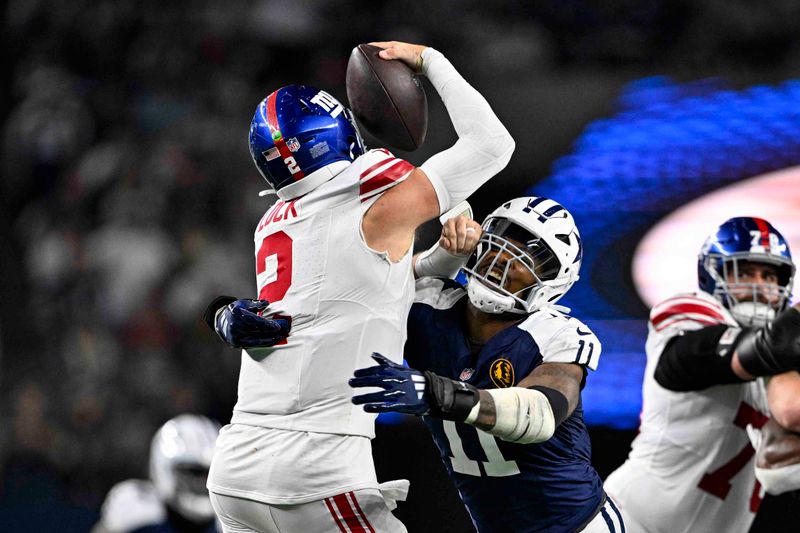 Dallas Cowboys linebacker Micah Parsons (11) sacks New York Giants quarterback Drew Lock (2) during the second half of an NFL football game in Arlington, Texas, Thursday, Nov. 28, 2024. (AP Photo/Jerome Miron)