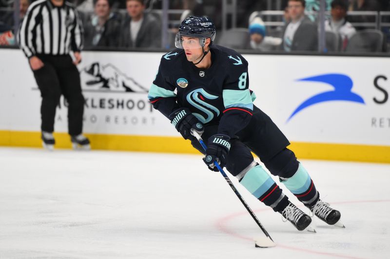 Mar 14, 2024; Seattle, Washington, USA; Seattle Kraken defenseman Brian Dumoulin (8) plays the puck against the Washington Capitals during the third period at Climate Pledge Arena. Mandatory Credit: Steven Bisig-USA TODAY Sports