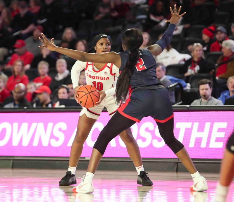 Jan 21, 2024; Athens, Georgia, USA; Georgia Bulldogs guard De   Mauri Flournoy (10) is defended by Ole Miss Rebels guard Marquesha Davis (2) during the second half at Stegeman Coliseum. Mandatory Credit: Mady Mertens-USA TODAY Sports