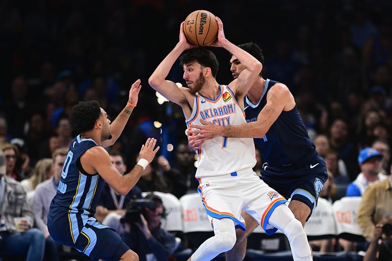 OKLAHOMA CITY, OKLAHOMA - DECEMBER 18: Chet Holmgren #7 of the Oklahoma City Thunder handles the ball while being defended by Santi Aldama #7 (R) and Jacob Gilyard #0 of the Memphis Grizzlies during the first half at Paycom Center on December 18, 2023 in Oklahoma City, Oklahoma. NOTE TO USER: User expressly acknowledges and agrees that, by downloading and or using this Photograph, user is consenting to the terms and conditions of the Getty Images License Agreement. (Photo by Joshua Gateley/Getty Images)