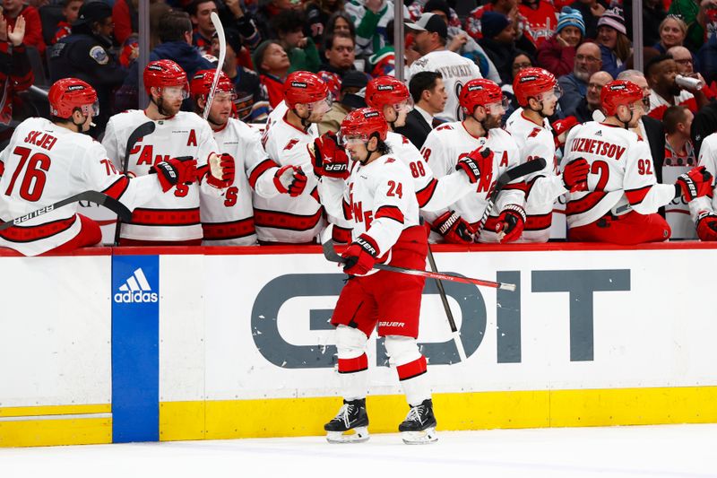 Mar 22, 2024; Washington, District of Columbia, USA; Carolina Hurricanes center Seth Jarvis (24) celebrates with teammates on the bench after scoring a goal during the third period at Capital One Arena. Mandatory Credit: Amber Searls-USA TODAY Sports