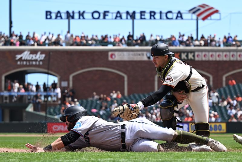 May 21, 2023; San Francisco, California, USA; San Francisco Giants catcher Patrick Bailey (14) tags out  Miami Marlins infielder Jon Berti (5) in a rundown play during the fifth inning at Oracle Park. Mandatory Credit: Robert Edwards-USA TODAY Sports