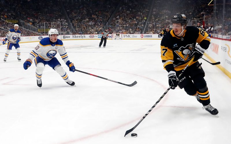 Jan 6, 2024; Pittsburgh, Pennsylvania, USA;  Pittsburgh Penguins right wing Rickard Rakell (67) handles the puck against the Buffalo Sabres during the first period at PPG Paints Arena. Mandatory Credit: Charles LeClaire-USA TODAY Sports