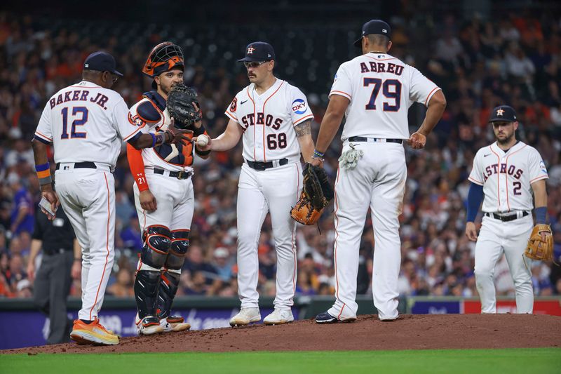 May 17, 2023; Houston, Texas, USA; Houston Astros starting pitcher J.P. France (68) hands the ball to manager Dusty Baker Jr. (12) during a pitching change in the fourth inning against the Chicago Cubs at Minute Maid Park. Mandatory Credit: Troy Taormina-USA TODAY Sports