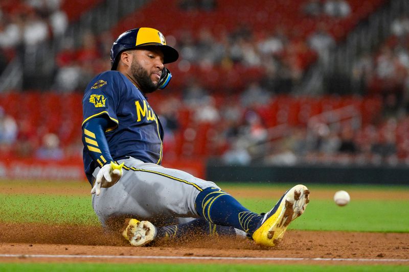 Apr 25, 2025; St. Louis, Missouri, USA;  Milwaukee Brewers left fielder Jackson Chourio (11) slides in at third base against the St. Louis Cardinals during the eighth inning at Busch Stadium. Mandatory Credit: Jeff Curry-Imagn Images