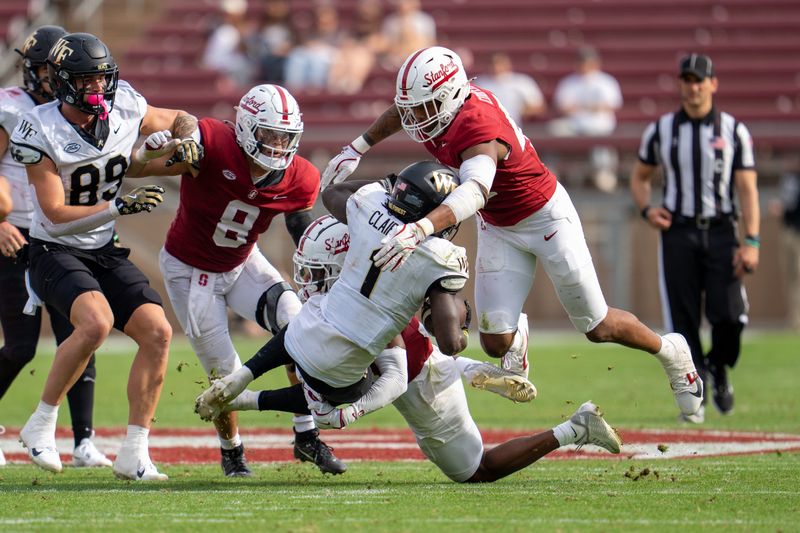 Oct 26, 2024; Stanford, California, USA;  Wake Forest Demon Deacons running back Demond Claiborne (1) is tackled after a first down by Stanford Cardinal linebacker Ernest Cooper (44) during the third quarter at Stanford Stadium. Mandatory Credit: Neville E. Guard-Imagn Images