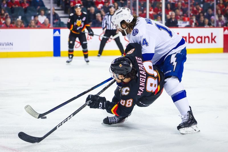 Jan 21, 2023; Calgary, Alberta, CAN; Calgary Flames left wing Andrew Mangiapane (88) and Tampa Bay Lightning left wing Pat Maroon (14) battle for the puck during the first period at Scotiabank Saddledome. Mandatory Credit: Sergei Belski-USA TODAY Sports