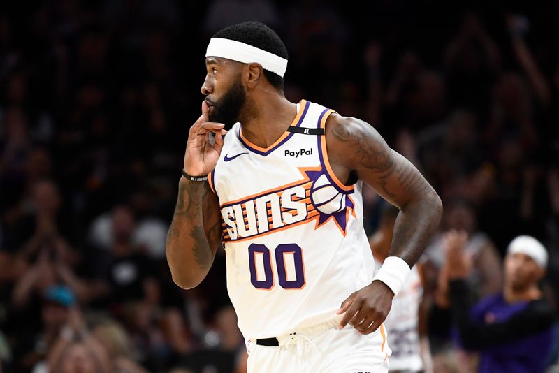 PHOENIX, ARIZONA - OCTOBER 11: Royce O'Neale #00 of the Phoenix Suns reacts after scoring against the Detroit Pistons during the first half of preseason game at Footprint Center on October 11, 2024 in Phoenix, Arizona. NOTE TO USER: User expressly acknowledges and agrees that, by downloading and/or using this photograph, user is consenting to the terms and conditions of the Getty Images License Agreement. (Photo by Kelsey Grant/Getty Images)