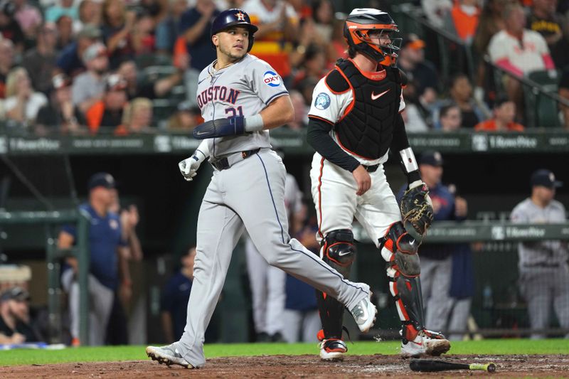 Aug 22, 2024; Baltimore, Maryland, USA; Houston Astros first baseman Yainer Diaz (21) rounds the bases to score during the fourth inning against Baltimore Orioles catcher Adley Rutschman (35) at Oriole Park at Camden Yards. Mandatory Credit: Mitch Stringer-USA TODAY Sports