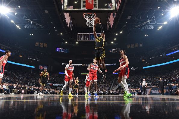 SAN FRANCISCO, CA - DECEMBER 22: Jonathan Kuminga #00 of the Golden State Warriors drives to the basket during the game against the Washington Wizards on December 22, 2023 at Chase Center in San Francisco, California. NOTE TO USER: User expressly acknowledges and agrees that, by downloading and or using this photograph, user is consenting to the terms and conditions of Getty Images License Agreement. Mandatory Copyright Notice: Copyright 2023 NBAE (Photo by Noah Graham/NBAE via Getty Images)