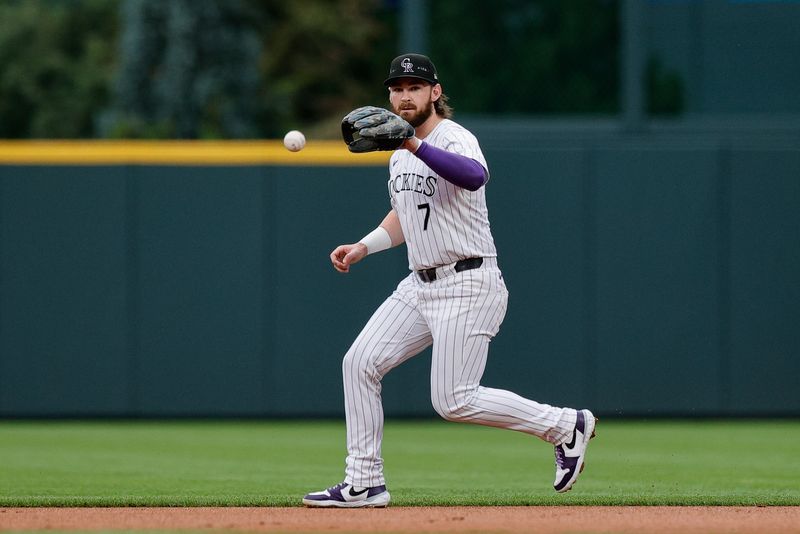 Aug 9, 2024; Denver, Colorado, USA; Colorado Rockies second baseman Brendan Rodgers (7) fields the ball in the first inning against the Atlanta Braves at Coors Field. Mandatory Credit: Isaiah J. Downing-USA TODAY Sports