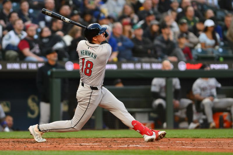 Apr 26, 2024; Seattle, Washington, USA; Arizona Diamondbacks shortstop Kevin Newman (18) hits a home run against the Seattle Mariners during the sixth inning at T-Mobile Park. Mandatory Credit: Steven Bisig-USA TODAY Sports