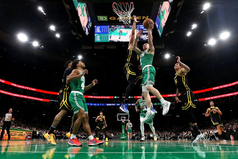 BOSTON, MASSACHUSETTS - MARCH 03: Payton Pritchard #11 of the Boston Celtics takes a shot against Jerome Robinson #18 of the Golden State Warriors at TD Garden on March 03, 2024 in Boston, Massachusetts. The Celtics defeat the Warriors 140-88. NOTE TO USER: User expressly acknowledges and agrees that, by downloading and or using this photograph, user is consenting to the terms and conditions of the Getty Images License Agreement.  (Photo by Maddie Meyer/Getty Images)