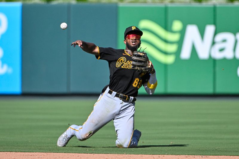 Sep 3, 2023; St. Louis, Missouri, USA;  Pittsburgh Pirates shortstop Liover Peguero (60) throws from his knees during the eighth inning against the St. Louis Cardinals at Busch Stadium. Mandatory Credit: Jeff Curry-USA TODAY Sports