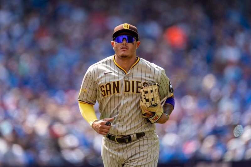 Jul 20, 2023; Toronto, Ontario, CAN; San Diego Padres third baseman Manny Machado (13) returns to the dugout after the seventh inning against the Toronto Blue Jays at Rogers Centre. Mandatory Credit: Kevin Sousa-USA TODAY Sports