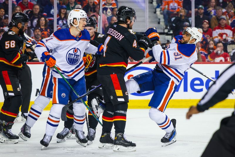 Apr 6, 2024; Calgary, Alberta, CAN; Calgary Flames defenseman Rasmus Andersson (4) checks Edmonton Oilers left wing Evander Kane (91) during the first period at Scotiabank Saddledome. Mandatory Credit: Sergei Belski-USA TODAY Sports