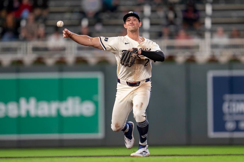 Apr 22, 2025; Minneapolis, Minnesota, USA; Minnesota Twins third baseman Brooks Lee (2) throws the ball to first base for an out against the Chicago White Sox in the eighth inning at Target Field. Mandatory Credit: Jesse Johnson-Imagn Images