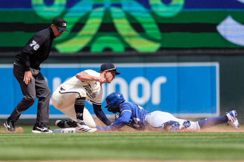 May 25, 2025; Minneapolis, Minnesota, USA; Minnesota Twins second baseman Brooks Lee (2) tags out Kansas City Royals center fielder Dairon Blanco (44) on a steal attempt during the ninth inning at Target Field. Mandatory Credit: Matt Krohn-Imagn Images