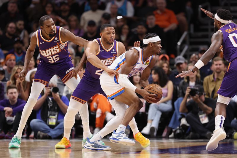 PHOENIX, ARIZONA - MARCH 03: Shai Gilgeous-Alexander #2 of the Oklahoma City Thunder drives the ball past Eric Gordon #23 of the Phoenix Suns during the first half of the NBA game at Footprint Center on March 03, 2024 in Phoenix, Arizona. NOTE TO USER: User expressly acknowledges and agrees that, by downloading and or using this photograph, User is consenting to the terms and conditions of the Getty Images License Agreement. (Photo by Christian Petersen/Getty Images)