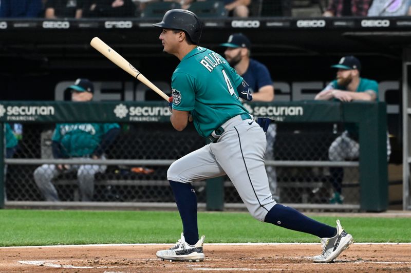 Aug 21, 2023; Chicago, Illinois, USA;  Seattle Mariners third baseman Josh Rojas (4) hits an RBI single against the Chicago White Sox during the first inning at Guaranteed Rate Field. Mandatory Credit: Matt Marton-USA TODAY Sports