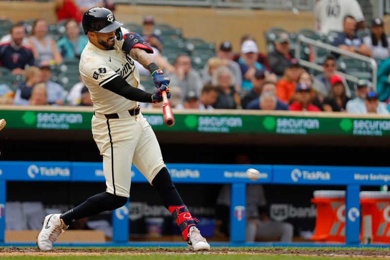 Jun 12, 2024; Minneapolis, Minnesota, USA; Minnesota Twins shortstop Carlos Correa (4) hits an RBI single against the Colorado Rockies in the fourth inning at Target Field. Mandatory Credit: Bruce Kluckhohn-USA TODAY Sports