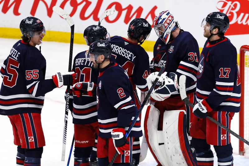 Mar 14, 2026; Winnipeg, Manitoba, CAN; Winnipeg Jets players celebrate their victory against the Colorado Avalanche at Canada Life Centre. Mandatory Credit: James Carey Lauder-Imagn Images