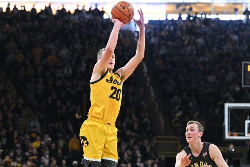 Jan 20, 2024; Iowa City, Iowa, USA; Iowa Hawkeyes forward Payton Sandfort (20) shoots the ball as Purdue Boilermakers guard Fletcher Loyer (2) looks on during the second half at Carver-Hawkeye Arena. Mandatory Credit: Jeffrey Becker-USA TODAY Sports